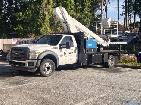 2× Versalift Boom Trucks — Lee's Signs shop equipment